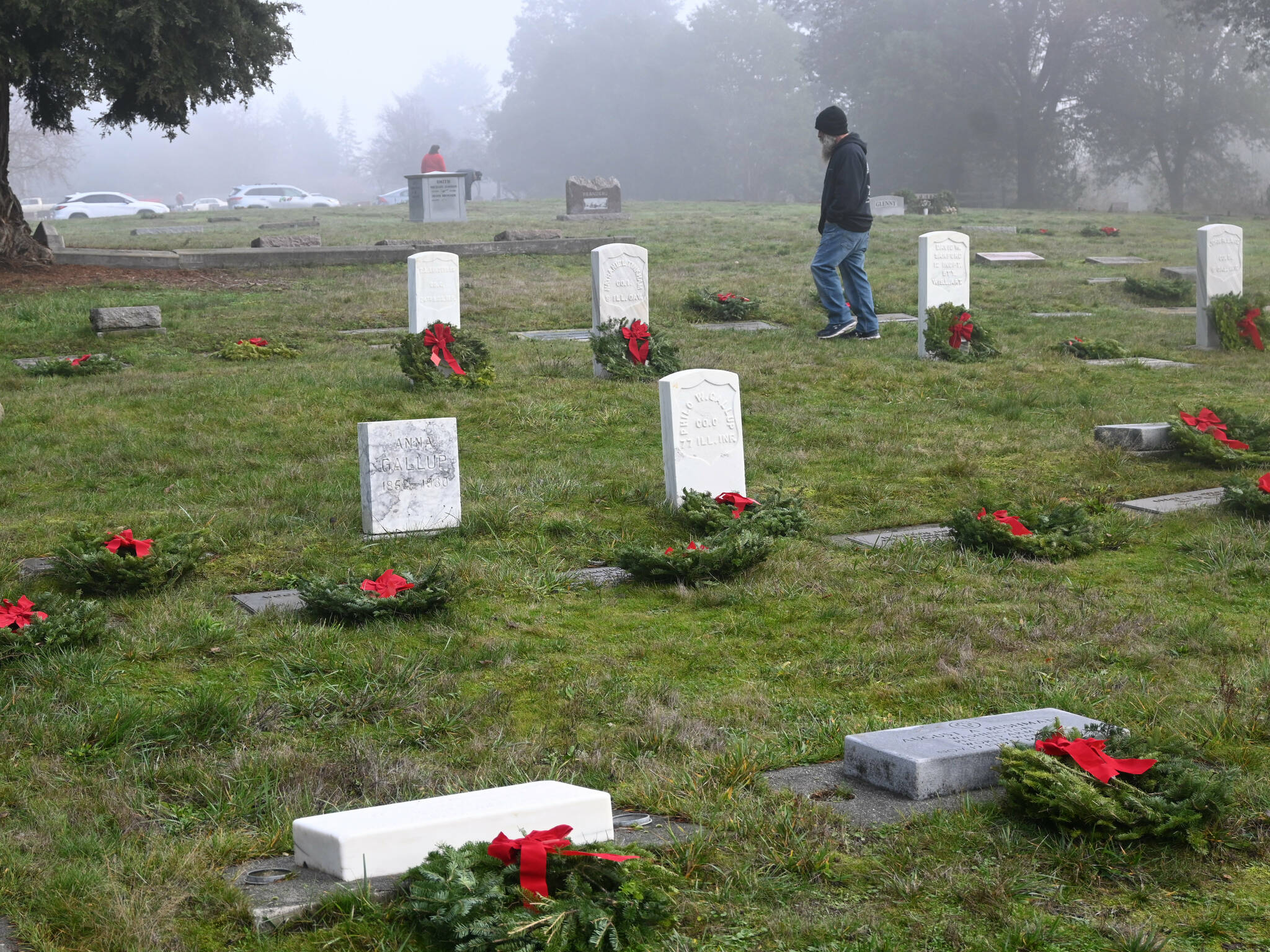 Sequim Gazette file photo by Michael Dashiell 
Community members placed balsam wreaths on grave markers at Sequim View Cemetery last December for Wreaths Across America (WAA). This year, in collaboration with the Michael Trebert DAR Chapter, wreaths will be placed again across Sequim on Dec. 14, including Sequim View Cemetery. The Mount Angeles Memorial Park Cemetery hosts a public ceremony at 9 a.m. the same day.