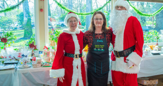 Sequim Gazette photo by Emily Matthiessen
Santa and Mrs. Claus (played by Ellen and John Castleman) stand with Della LaCour, who originated the idea to bring back the Sequim Prairie Garden Club’s tea event on Dec. 7. She said that when members of the club were going through old scrapbooks upon their 75th anniversary last year, “we came across pictures of the tea,” and they would like to make it a tradition going forward.