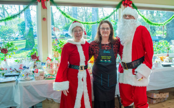 Sequim Gazette photo by Emily Matthiessen
Santa and Mrs. Claus (played by Ellen and John Castleman) stand with Della LaCour, who originated the idea to bring back the Sequim Prairie Garden Club’s tea event on Dec. 7. She said that when members of the club were going through old scrapbooks upon their 75th anniversary last year, “we came across pictures of the tea,” and they would like to make it a tradition going forward.