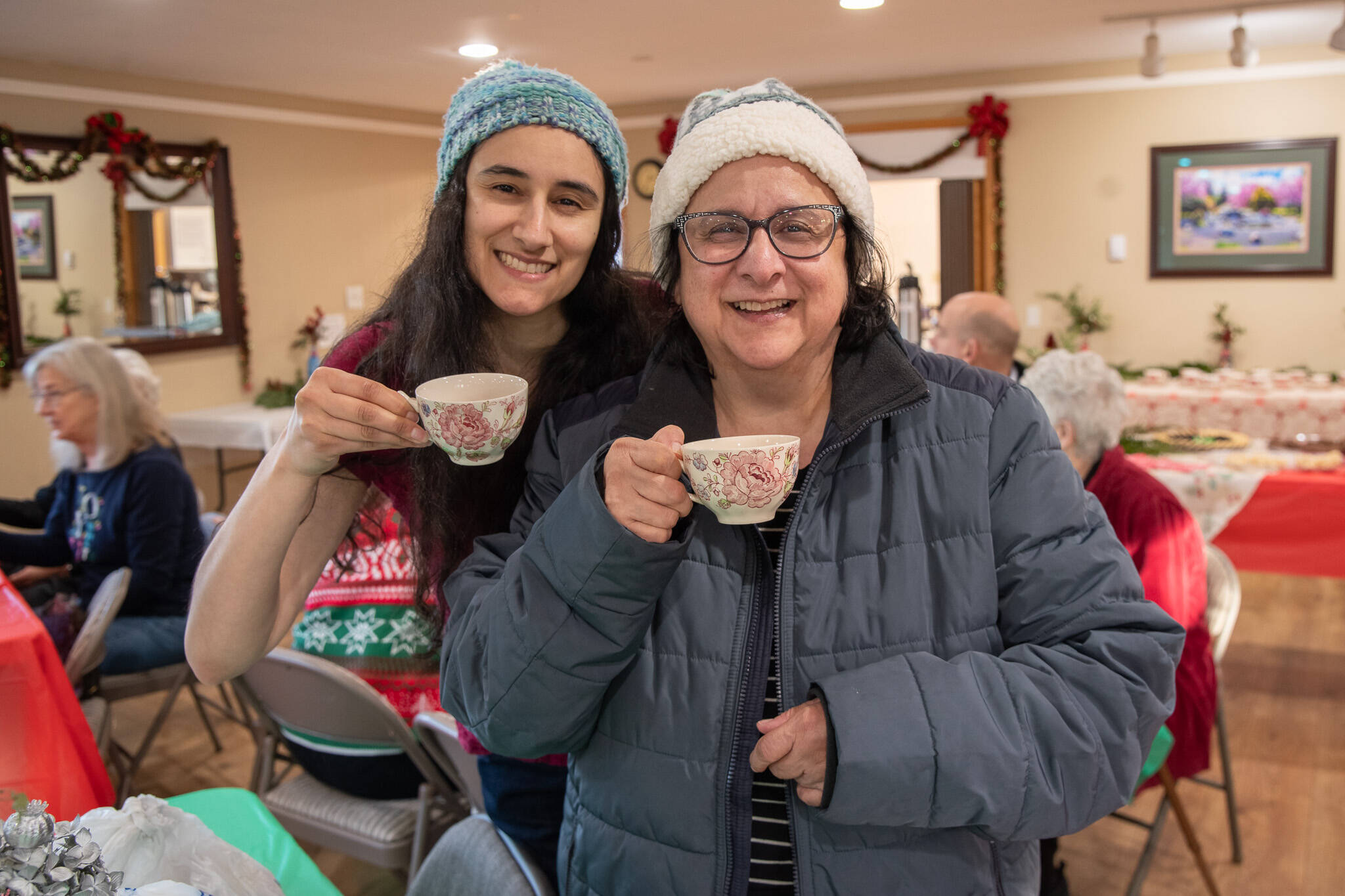 Sequim Gazette photo by Emily Matthiessen/ Daughter Claire Muggia, left, and mother Paula Muggia made a special effort to find a holiday tea and come out to Sequim from Port Angeles for the Sequim Prairie Garden Club’s first annual tea last Saturday. “(It’s) very welcoming,” said Paula Muggia. “They really created a wonderful atmosphere. The warm spirit of Christmas encapsulated in a cup of tea.”