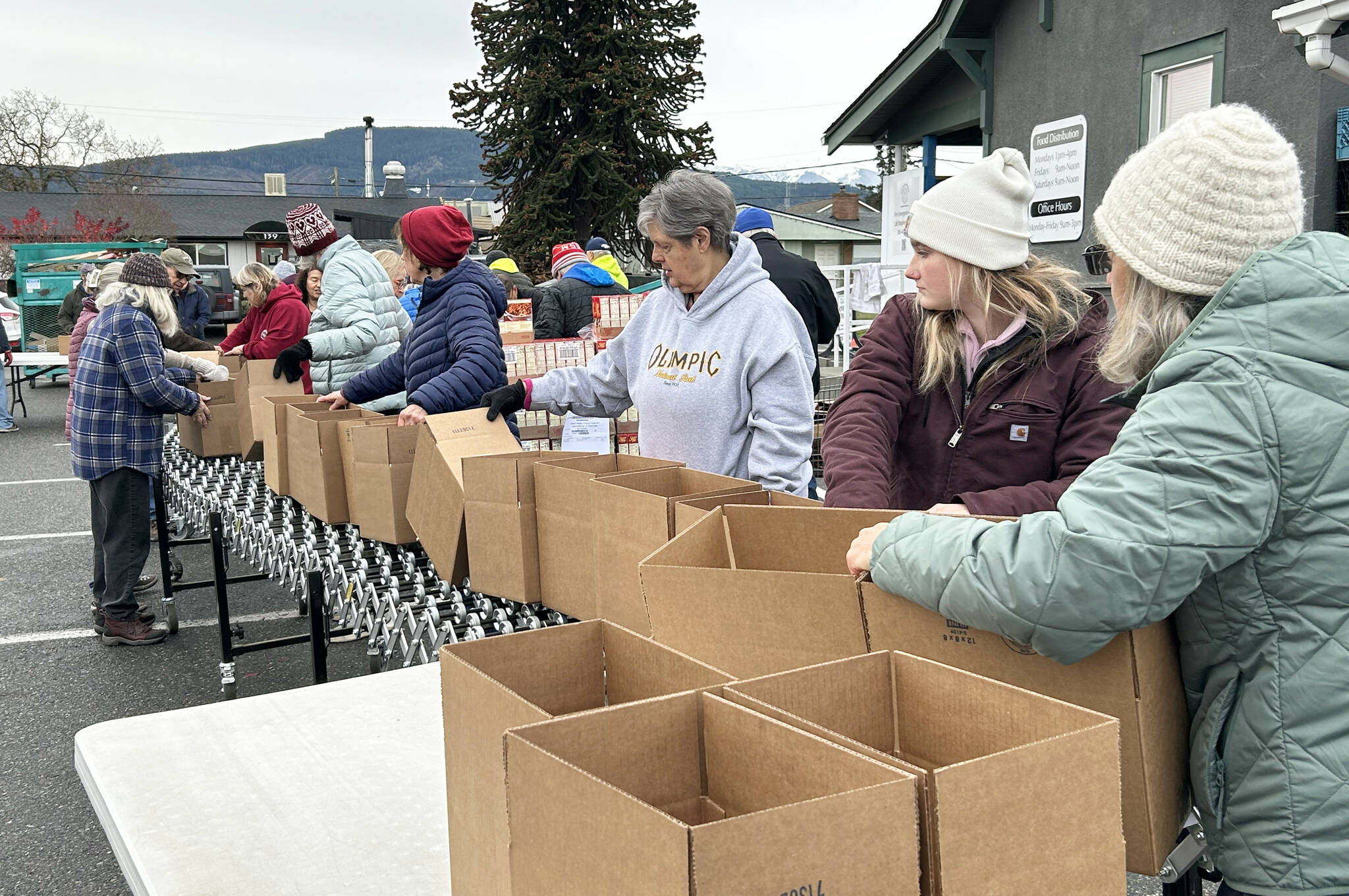 Sequim Gazette file photo by Matthew Nash
Volunteers prep boxes for the Holiday Meal Bag program for Thanksgiving in November at the Sequim Food Bank. The event returns to offer free boxed meals for families from 11 a.m.-2 p.m. Friday, Dec. 20 in Carrie Blake Community Park.