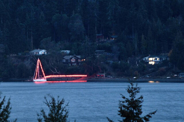 Photo by Doug Schwarz
For 20-plus years, Bob and Kelly Macaulay have decorated their boat and dock off East Sequim Bay Road for Christmas, seen here more than a mile away. However, the couple sold their boat earlier this year and wanted residents to know.