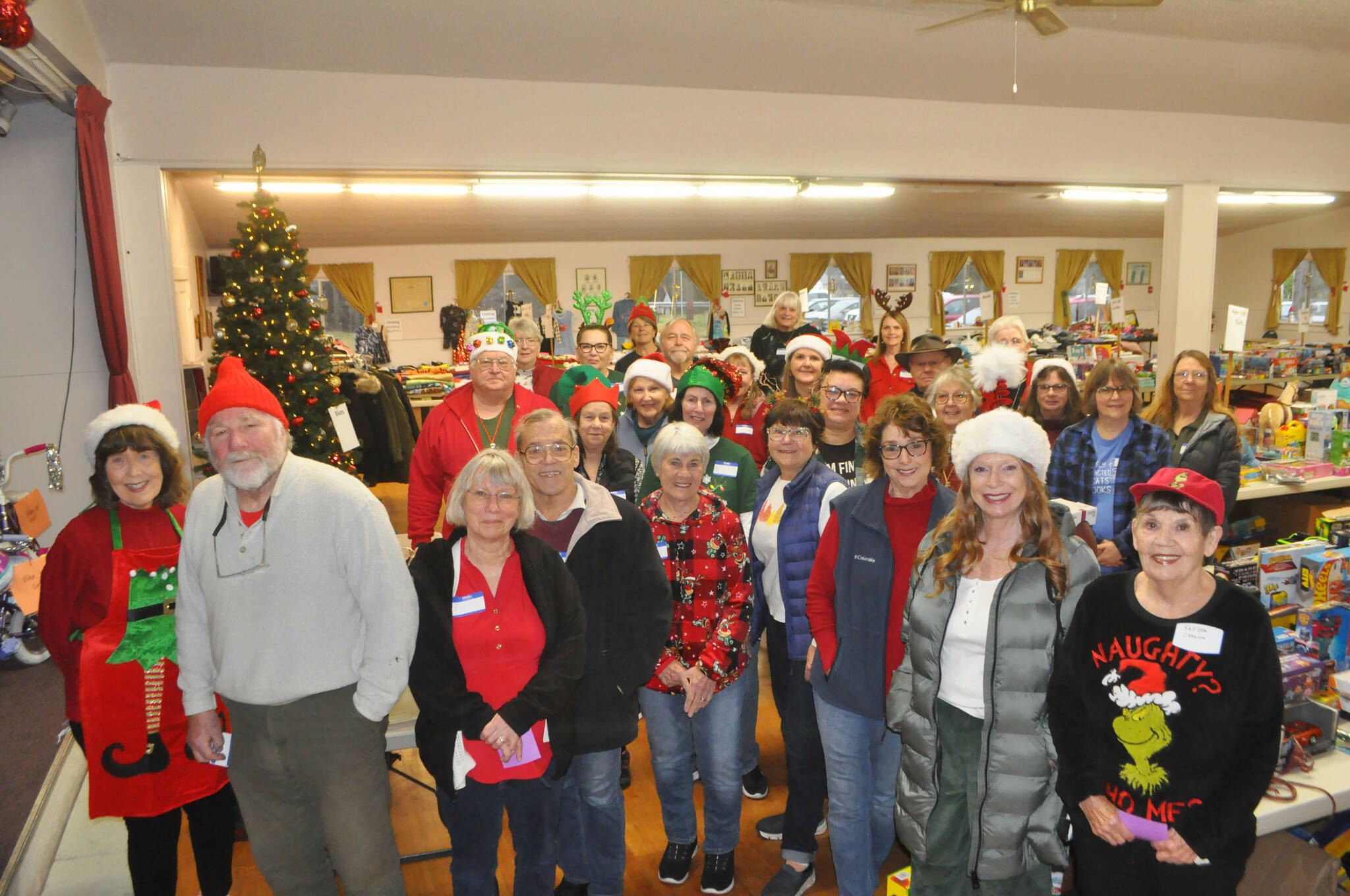 Sequim Gazette photos by Matthew Nash
Toys for Sequim Kids volunteers stand together before they open the doors to Sequim Prairie Grange on Dec. 17. They helped distribute gifts for 400-plus local children this Christmas.