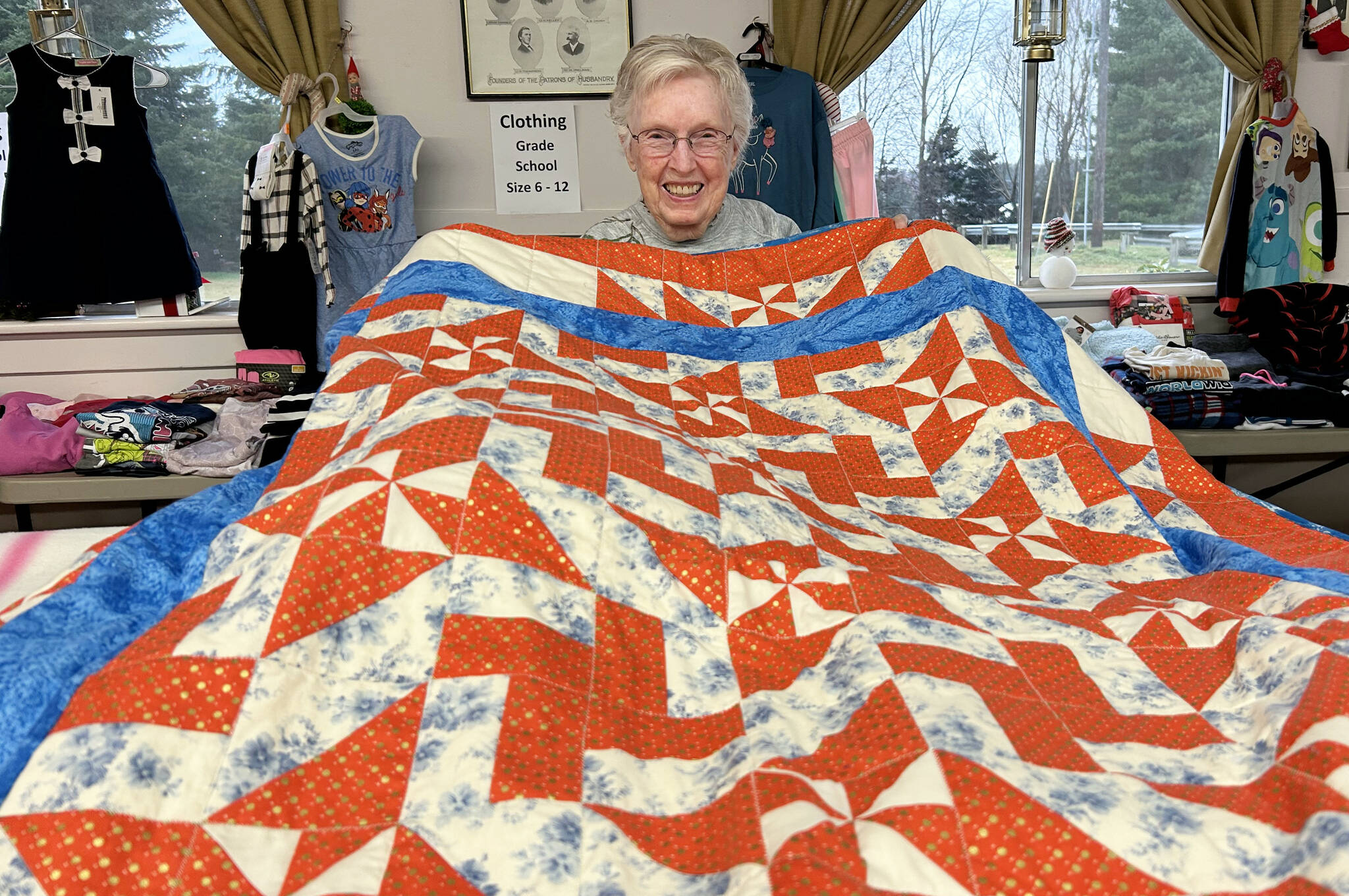 Sequim Gazette photo by Matthew Nash
LaRue Robirts shows one of the quilts she made for Toys for Sequim Kids on Dec. 17 in Sequim Prairie Grange. By her count, she’s made and donated more than 1,400 quilts to community efforts.