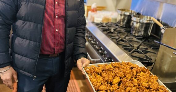 Sequim Gazette photo by Kathy Cruz 
Harinderbir Nagra, co-owner of Hardy’s Market, shows off a tray of onion bhaji, onion fritters seasoned with ginger and spices, as the store prepared to launch its new Indian food takeout menu last week.