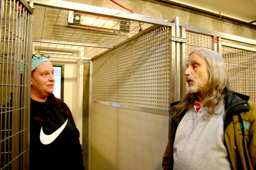 Red Parsons, left, Kitty City assistant manager who will help run the Bark House, and Paul Stehr-Green, Olympic Peninsula Humane Society board president and acting executive director, stand near dog kennels discussing the changes they are making to the Bark House to ensure dogs are in a comfortable, sanitary environment when the facility reopens in February. (Emma Maple/Peninsula Daily News)